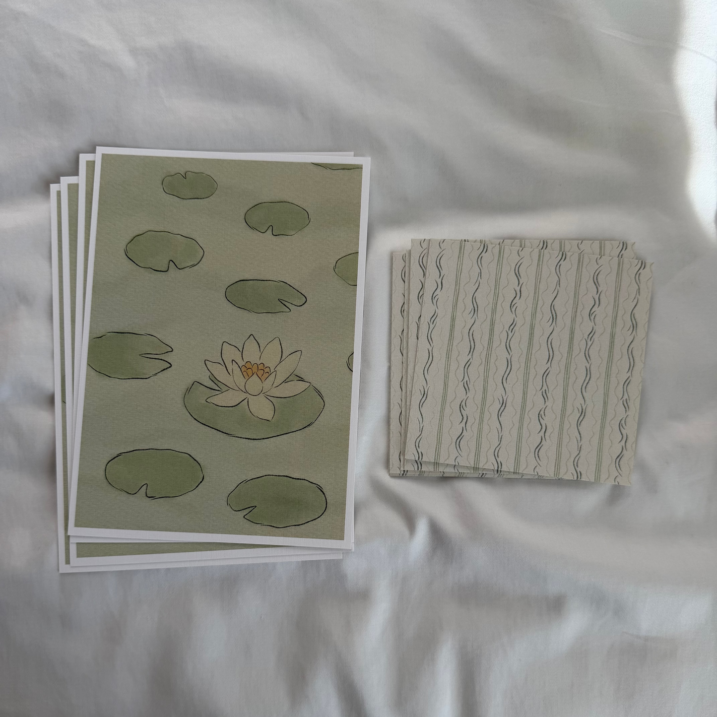 A 5x7 water lily art print paired with a matching 4x4 dainty patterned print in soft sage green tones.